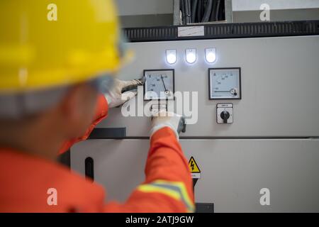 Electrical engineers inspect the power meter system in the building. Stock Photo