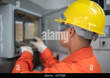 Technicians are checking the telephone line system in the building. Stock Photo