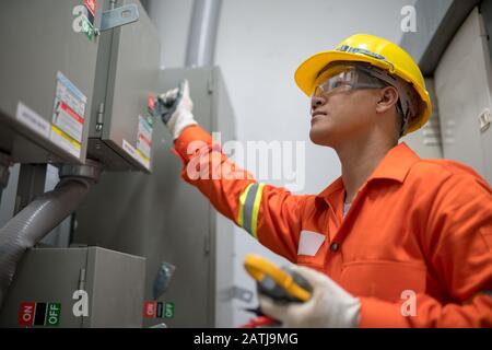 Electrician engineer checking electricity system in the box room energy building Stock Photo