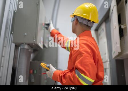 Electrician man working in the electricity building Stock Photo