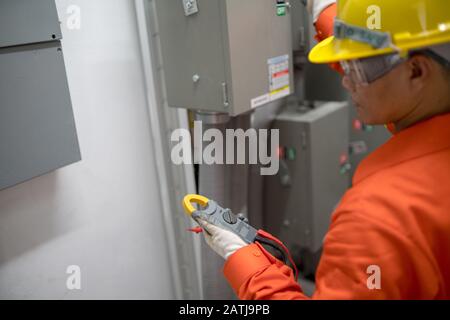 An electrical engineer inspects the electrical system in the building. Stock Photo