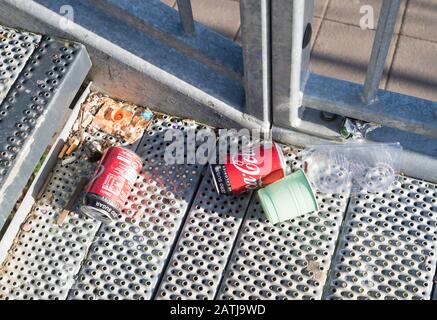 Litter comprising drinks cans and plastic items lying on a footbridge in Washington, north east England, UK Stock Photo