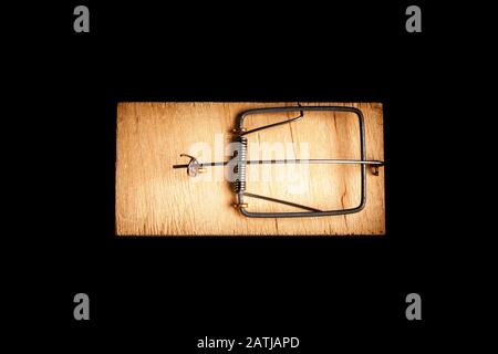 Mousetrap without bait isolate on a black background. Stock photo traps. Stock Photo