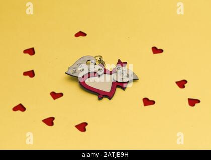 Heart shape love concept for valentines day, open empty wooden heart shape on yellow background. Stock Photo