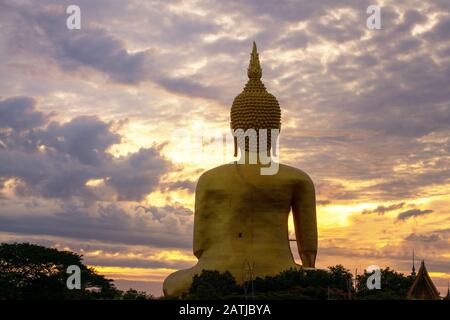 The golden Buddha statue during sunrise in Ang Thong Province Thailand Stock Photo