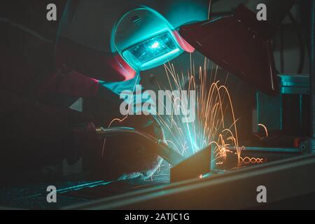 The welding male welder working in the workshop Stock Photo