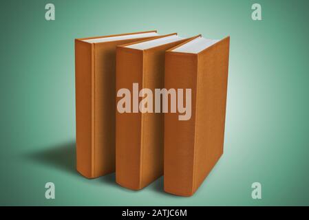 Three Closed big book with hardcover on green gradient background. Clipping path Stock Photo