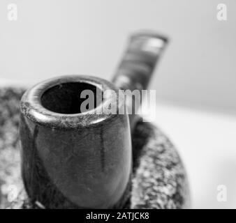 Macro picture red-brown pipe on an ashtray black and white Stock Photo
