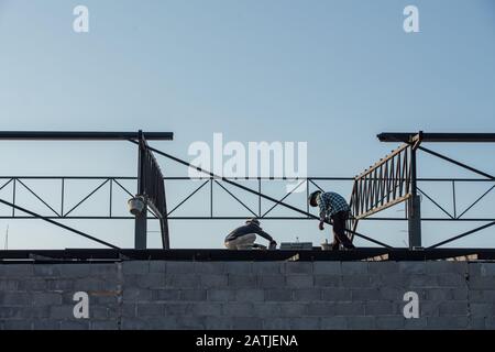 Construction worker two people working together on the construction site. Stock Photo