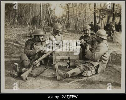 The British Western Front in France. The German offensive description: French and British Troops enjoy a card game during a rest from the fight Annotation: British Western Front in France. German offfensief. French and British troops playing cards during a lull Date: {1914-1918} Location: France Keywords: WWI, fronts, card games, soldiers, breaks Stock Photo