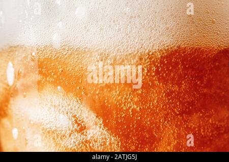 Gold background texture of yellow light beer with froth and bubbles in glass, copy space Stock Photo