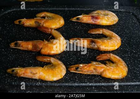 Prepared for cooking dinner seafood - shrimp on black cuting board, on a cutting slate board Stock Photo