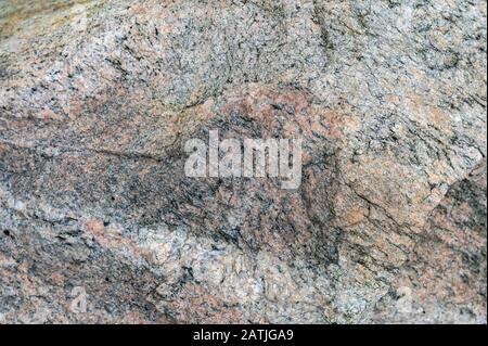 Closeup of multi-colored rock texture with plenty of cracks Stock Photo