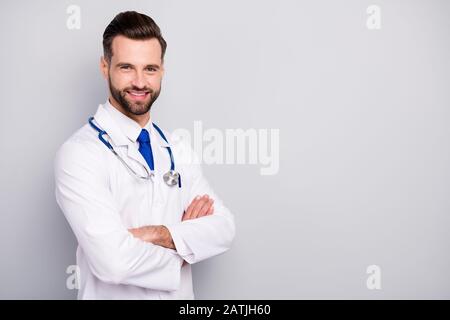 Profile side view portrait of his he nice attractive cheerful cheery content bearded guy qualified skilled specialist assistant expert folded arms Stock Photo