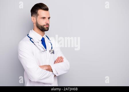 Profile side view portrait of his he nice attractive qualified skilled calm content virile masculine bearded guy doc expert folded arms isolated over Stock Photo