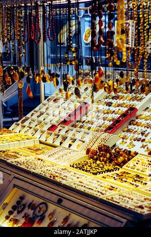 Market stall with baltic amber and silver jewellery souvenirs such as rings, pendant and necklaces Stock Photo