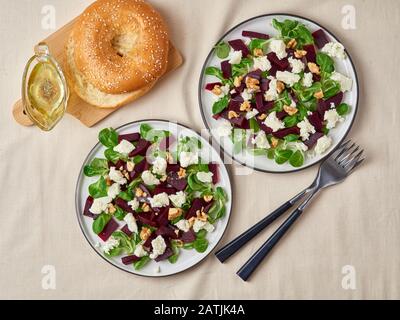 beetroot salad with feta, cheese, walnuts, corn salad and Brined cheese, pickled on white table, top view Stock Photo