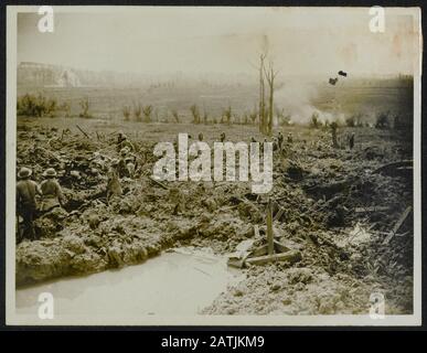 The British Western Front. Battle or Flanders description: Sappers digging a trench communication. Shells in background. Annotation: The British Western Front. The battle of Flanders. Sappers dug a communications trench. Grenades explode in the background. Date: {1914-1918} Location: Belgium Keywords: WWI, fronts, trenches, explosions, soldiers Stock Photo