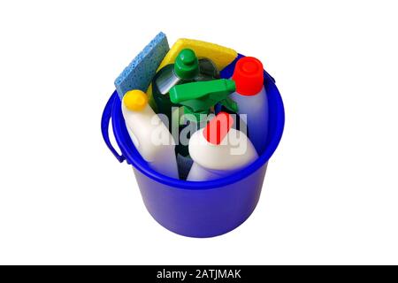 Variety of cleaning supplies in blue bucket isolated on white background. Cleaning detergents and household products. Isolate. Close up. Stock Photo