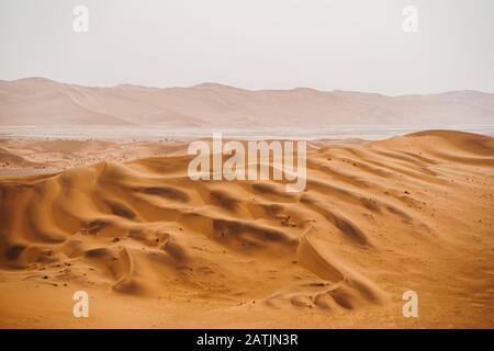 panoramic photo of beautiful red sand dunes at Sossusvlei in Namib Desert Stock Photo