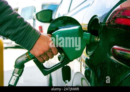Hand holding gasoline pomp Stock Photo