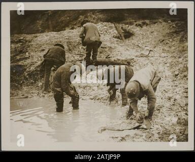 The Western Front Description: Tommies cleaning up Their trench waders. Annotation: The Western Front. British soldiers wash their waders. Date: {1914-1918} Keywords: WWI, fronts, waders, trenches, soldiers Stock Photo