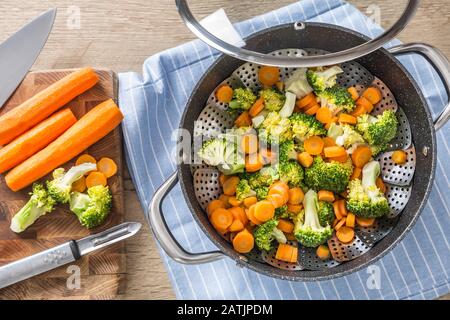 Steamed mixed vegetable in black pot. Healthy vegetable concept Stock Photo