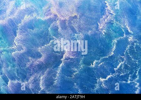 Venetian stucco of blue color with white stains. Background and texture of decorative plaster. Stock Photo