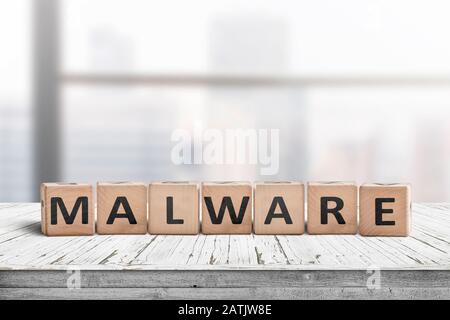 Malware message sign made of wood on a desk in a bright office environment Stock Photo