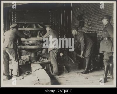 The British Western Front in France - the German offensive Description: British Military Tire Press in France, showing a tire being forced on a lorry wheel by hydraulic pressure Annotation: British Western Front in France. The German offensive. The British Military Bands Press in France; The photo shows a band that is placed around a vehicle wheel with the help of a hydraulic press Date: {1914-1918} Location: France Keywords: belt presses, First World War fronts, soldiers, workshops Stock Photo