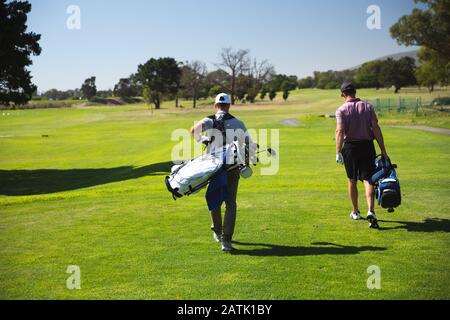 Golfers walking together with golf bag Stock Photo