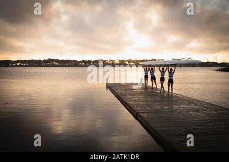 Female rowing team training on a river Stock Photo