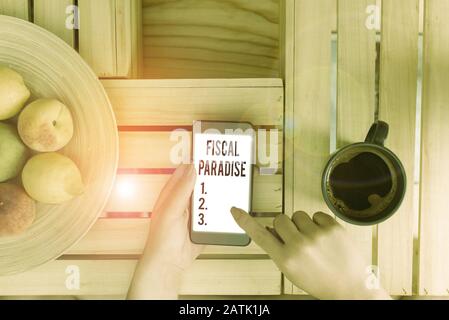 Conceptual hand writing showing Fiscal Paradise. Concept meaning Tax on development Rates of taxation for foreign investors Stock Photo