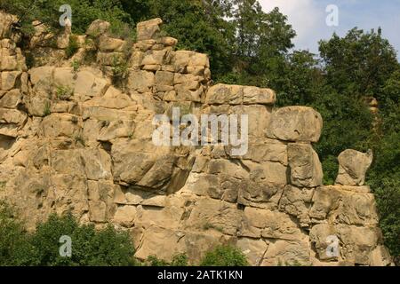 Interesting rock formation along Putna River's canyon in Vrancea, Romania. Natural cliff side of stacked boulders. Stock Photo