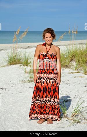 Beautiful Mature Woman Wearing a Sundress on the Beach Stock Photo - Alamy