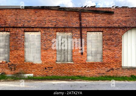 a boarded up old red brick building Stock Photo