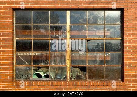 an abandoned warehouse building with old rusty window Stock Photo