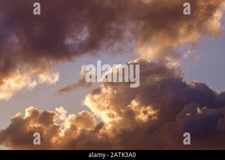 Large clouds in setting sun, backlight. Shades from white to black Stock Photo