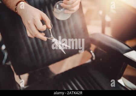 Barbershop Close-up of barber holds hair clipper Stock Photo