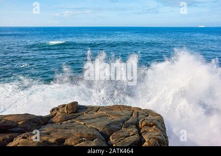 Waves crashing against the rocky shore, Sri Lanka.
