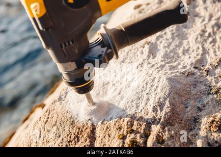 Drill for holes in stone and brick walls, professional tool Stock Photo