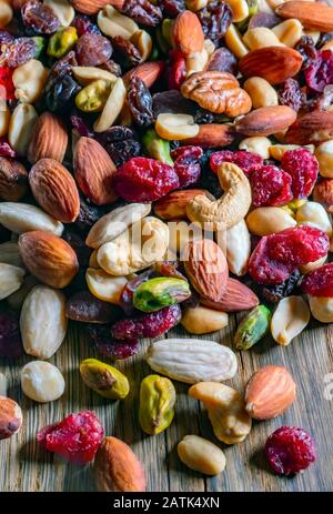 Roasted and salted nuts (mixed) on an old wooden table Stock Photo