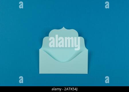 Communication, newsletter and business concept- blue colorful envelope on blue background, selective focus. Stock Photo