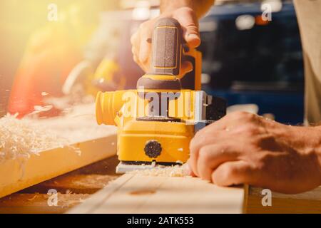 Electric mobile portable planer for processing wooden paintings on lumberjack Stock Photo