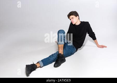 cool dramatic guy sitting in a fashion pose - Stock Image - Everypixel