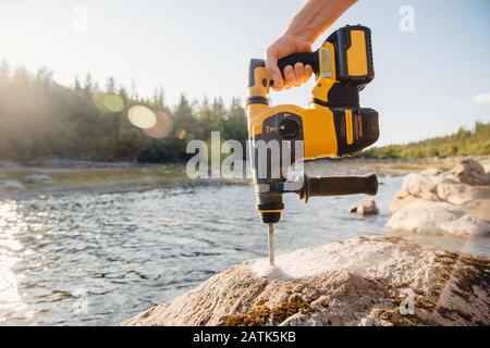 Electric mobile tool puncher drill for drilling stone and concrete walls Stock Photo