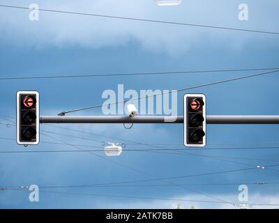 CCTV, Surveillance security camera with the traffic light and sign against a blue sky Stock Photo