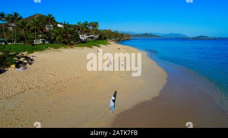 Aerial view down onto idyllic wide, sandy Lanikai Beach with calm turquoise waters rippling up on shore, Kailua, Oahu Island, Hawaii, USA Stock Photo