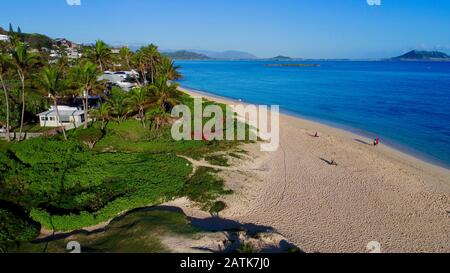 Aerial view down onto idyllic wide, sandy Lanikai Beach with calm turquoise waters rippling up on shore, Kailua, Oahu Island, Hawaii, USA Stock Photo