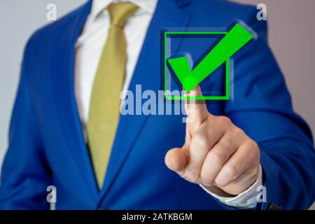 business man touching check mark on virtual screen with hand Stock Photo